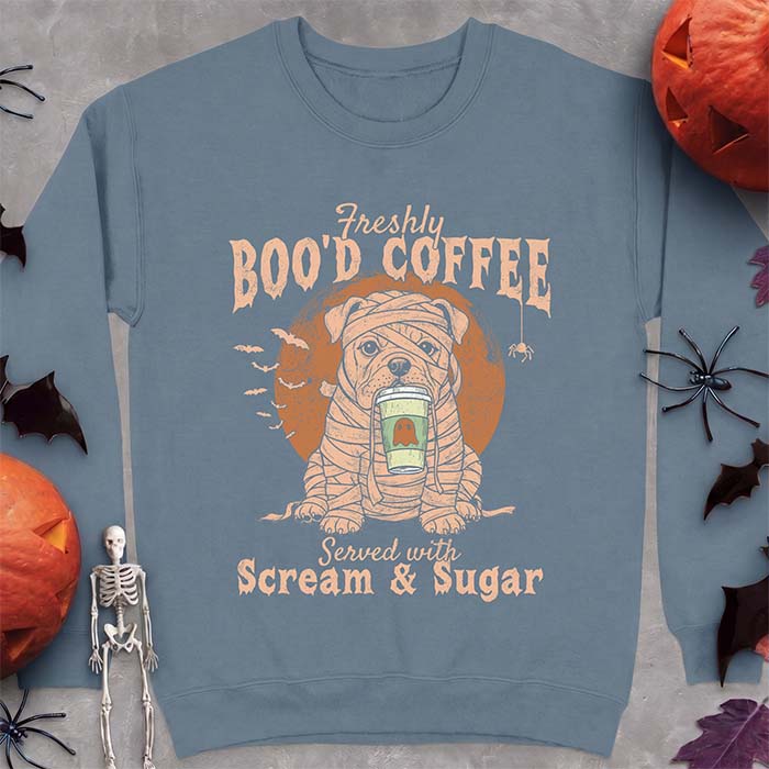 Indigo Blue sweatshirt with a Halloween graphic of a bulldog wrapped as a mummy holding a coffee cup, bats and a spider under a moon and the text Freshly Boo'd Coffee served with scream & sugar