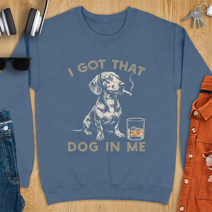 Indigo Blue sweatshirt with a graphic of a dachshund sitting with a cigar in its mouth and a glass of whiskey beside it and the text I Got That Dog In Me