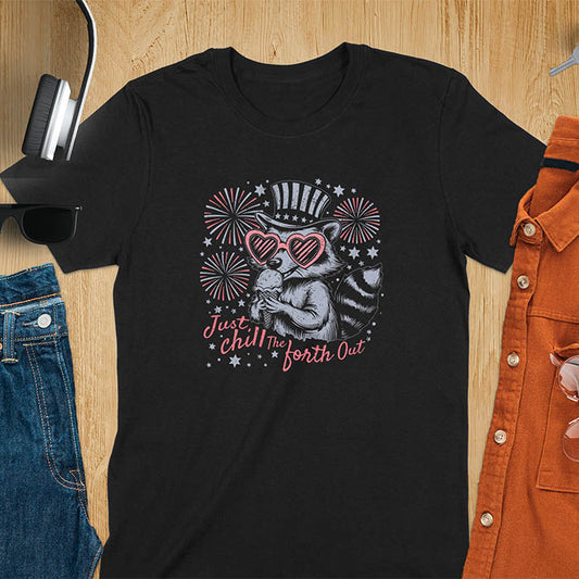 A black t-shirt with a raccoon in a patriotic top hat & heart sunglasses, holding an ice cream cone. Fireworks burst around it. Text: "JUST CHILL THE FOURTH OUT". This raccoon cuteness tee is a funny 4th of July fourth of july shirt for chill the 4th out. A fireworks shirt, patriotic merica tee & freedom t shirt for independence day. Has vintage aesthetics, a funny patriot animal person gift or mom gift among 4th of july shirts.