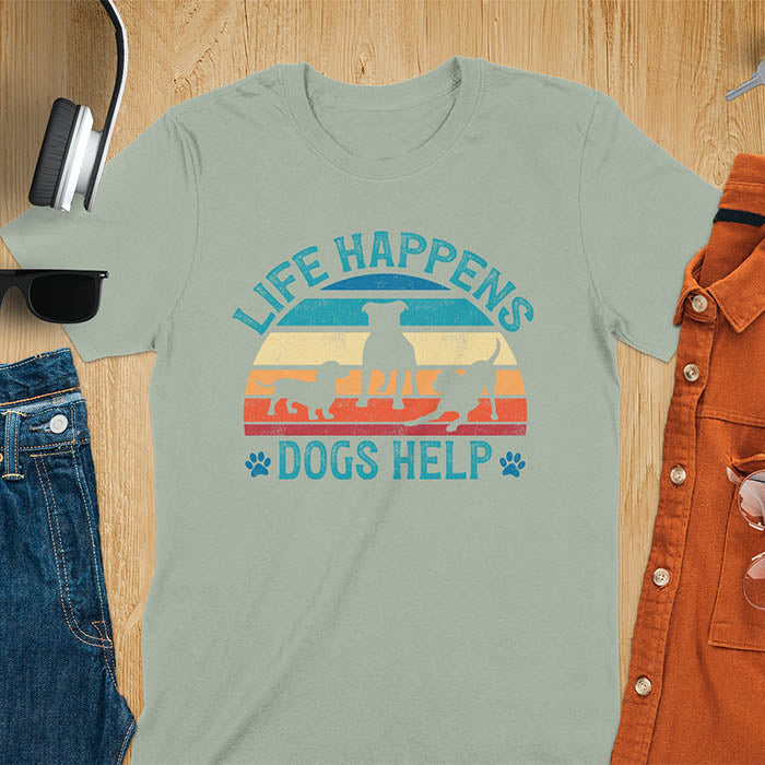 Life Happens Dogs Help vintage retro sunset with dog silhouettes and paw prints on sage green t-shirt