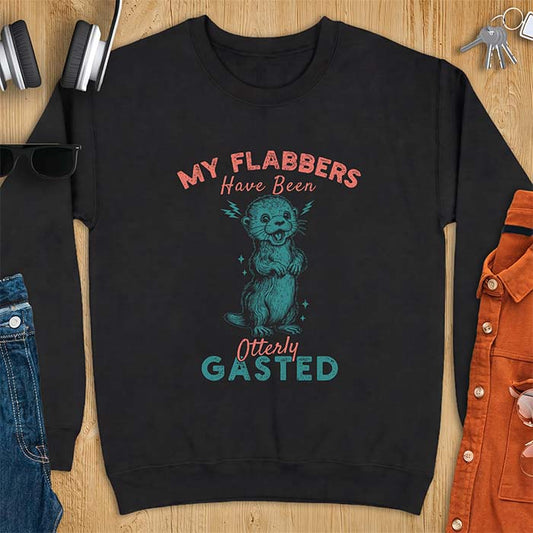 Black sweatshirt with a graphic of a startled otter standing upright with paws clasped and mouth open in shock with lightning bolts on either side, featuring the text My Flabbers Have Been Otterly Gasted.