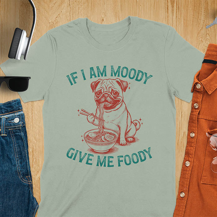 Sage green t-shirt with pug eating ramen with chopsticks graphic featuring 'If I Am Moody Give Me Foody' text - funny dog meme design