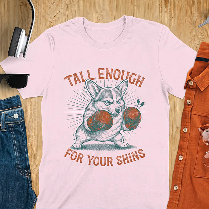 Light pink graphic tee with retro illustration of a corgi wearing boxing gloves, text reads Tall Enough For Your Shins