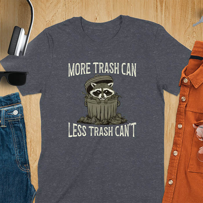 A fun and vintage retro T-Shirt featuring a funny raccoon with the phrase 'More trash can less trash can't'. This T-Shirt exudes a playful and lighthearted vibe, perfect for casual wear or lounging around.