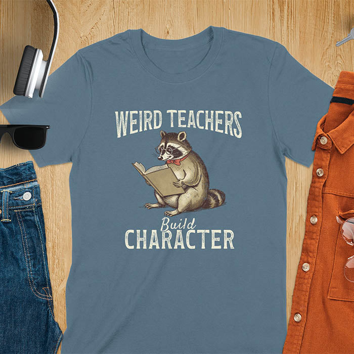 Weird Teachers Build Character shirt featuring a raccoon reading a book with glasses and a red bow tie. Vintage distressed font and brownish monotone give it a retro look. Perfect back-to-school shirt, funny teacher gift, or teacher appreciation tee.