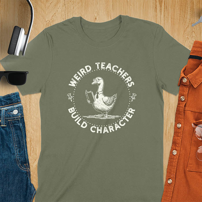 The design features a cartoon goose wearing glasses and holding a book. Surrounding the goose, there is text that reads, WEIRD TEACHERS BUILD CHARACTER.