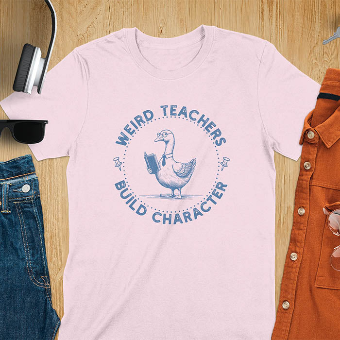 The design features a cartoon goose wearing glasses and holding a book. Surrounding the goose, there is text that reads, WEIRD TEACHERS BUILD CHARACTER.