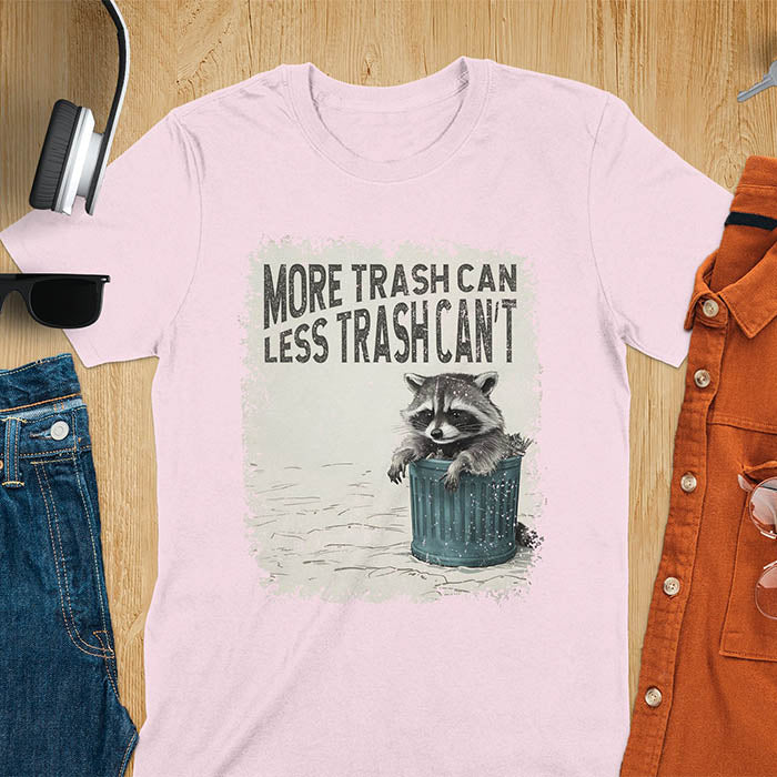 Raccoon lounging on a blue trash can with text "More Trash Can, Less Trash Can't." Distressed texture with vintage font. Perfect for animal lovers, sarcastic shirts, raccoon gifts, and fans of retro funny tees.