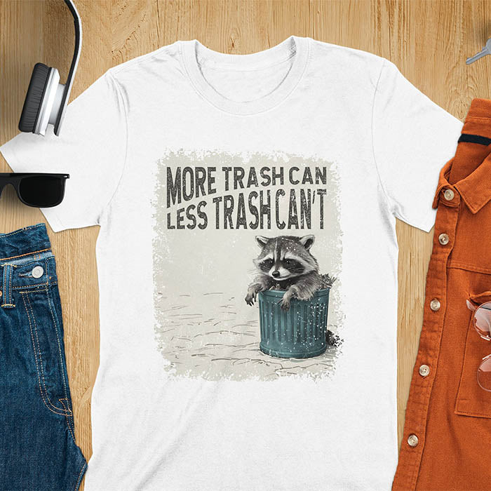 Raccoon lounging on a blue trash can with text "More Trash Can, Less Trash Can't." Distressed texture with vintage font. Perfect for animal lovers, sarcastic shirts, raccoon gifts, and fans of retro funny tees.