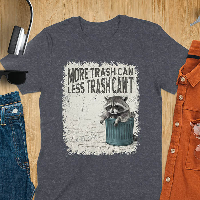 Raccoon lounging on a blue trash can with text "More Trash Can, Less Trash Can't." Distressed texture with vintage font. Perfect for animal lovers, sarcastic shirts, raccoon gifts, and fans of retro funny tees.