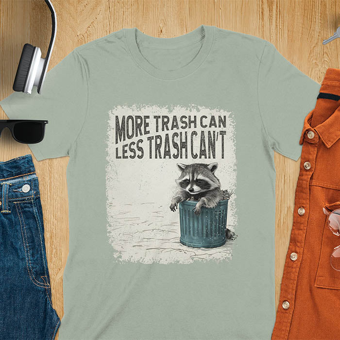 Raccoon lounging on a blue trash can with text "More Trash Can, Less Trash Can't." Distressed texture with vintage font. Perfect for animal lovers, sarcastic shirts, raccoon gifts, and fans of retro funny tees.