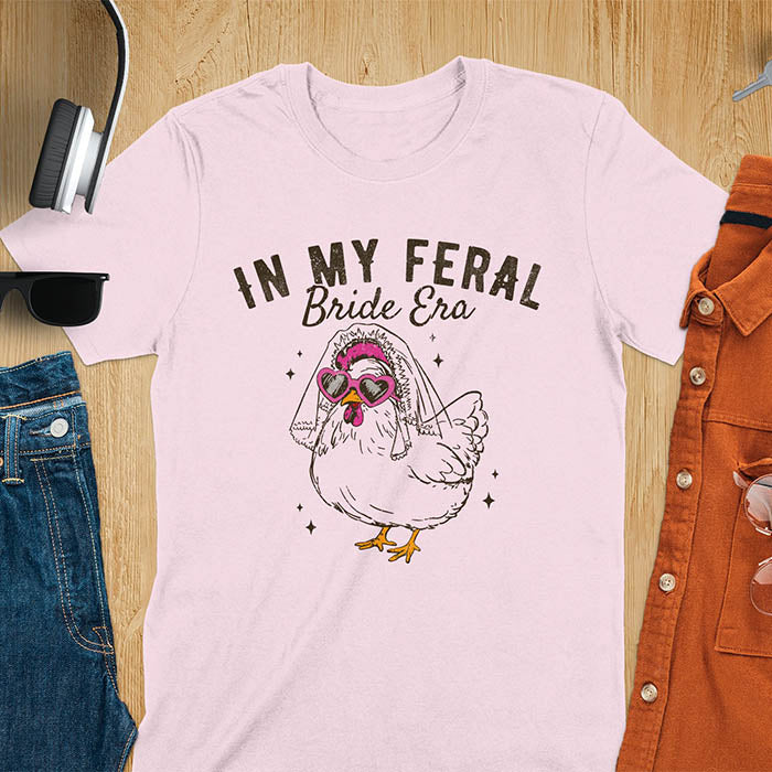 A chicken wearing sunglasses and a bride's veil, with the text "In My Feral Bride Era".