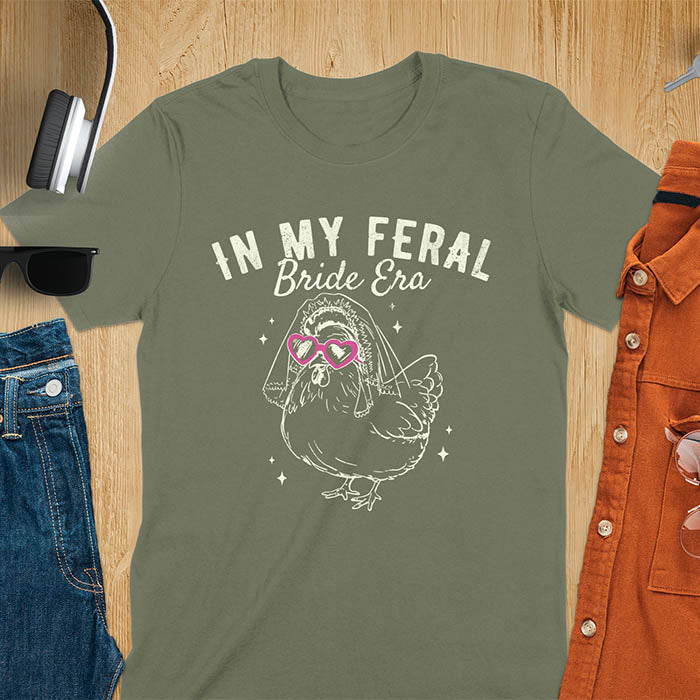 A chicken wearing sunglasses and a bride's veil, with the text "In My Feral Bride Era".