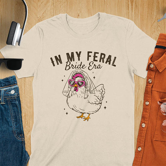 A chicken wearing sunglasses and a bride's veil, with the text "In My Feral Bride Era".