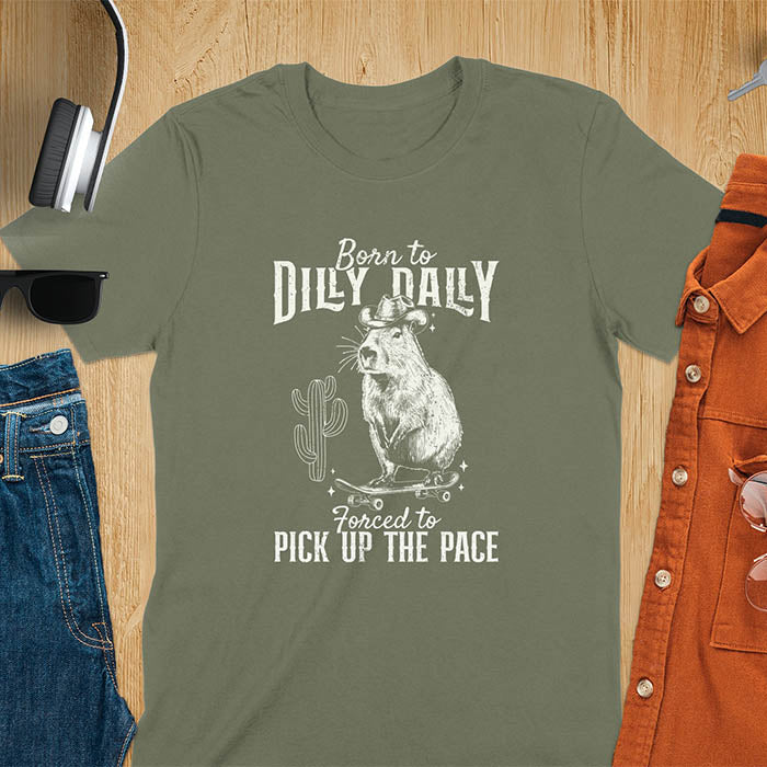 Capybara in a cowboy hat on a skateboard western style. Born to Dilly Dally and Forced to Pick Up the Pace text. Distressed style.