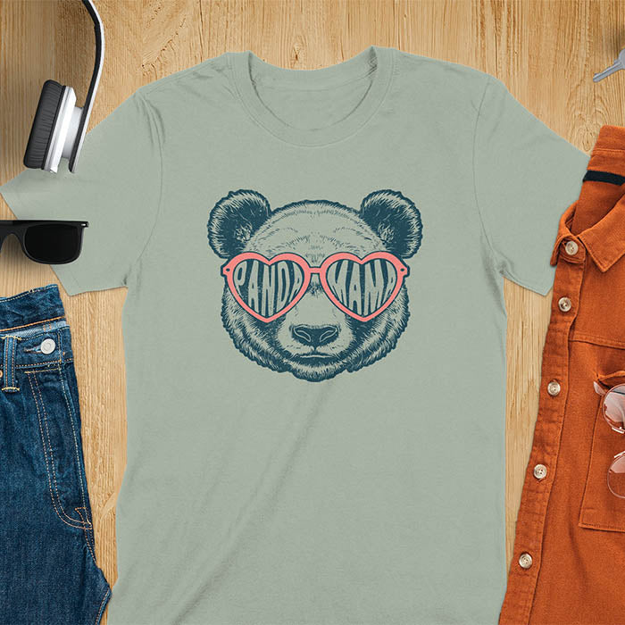 A t-shirt featuring a white panda face with pink heart-shaped sunglasses that spell PANDA MAMA. This mama shirt is a vintage mama t-shirt for a funny animal mom. A mom tee for a gift for mom or gift for grandmother. A mom birthday gift or gift for wife, or an expectant mom gift for a pregnancy announce. A great mother days shirt for mama.