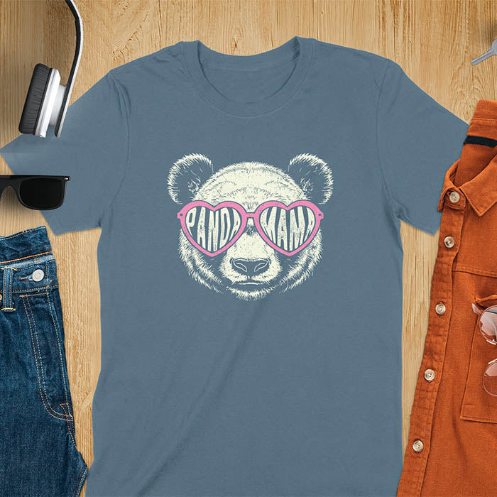 A t-shirt featuring a white panda face with pink heart-shaped sunglasses that spell PANDA MAMA. This mama shirt is a vintage mama t-shirt for a funny animal mom. A mom tee for a gift for mom or gift for grandmother. A mom birthday gift or gift for wife, or an expectant mom gift for a pregnancy announce. A great mother days shirt for mama.