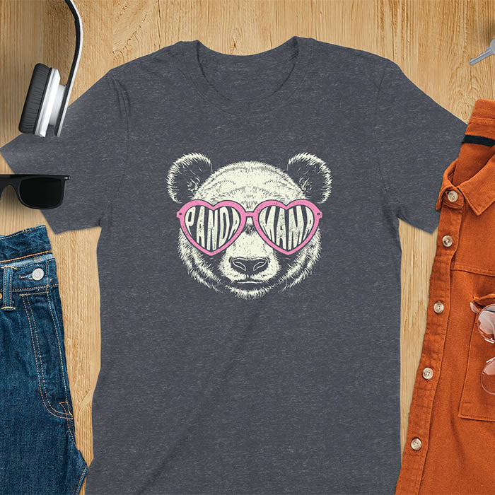 A t-shirt featuring a white panda face with pink heart-shaped sunglasses that spell PANDA MAMA. This mama shirt is a vintage mama t-shirt for a funny animal mom. A mom tee for a gift for mom or gift for grandmother. A mom birthday gift or gift for wife, or an expectant mom gift for a pregnancy announce. A great mother days shirt for mama.