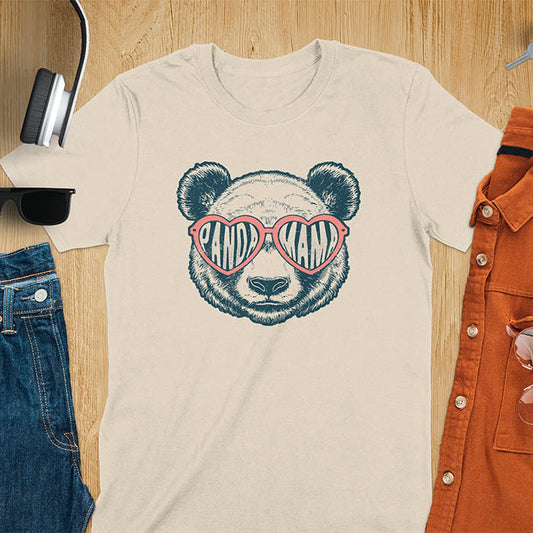 A t-shirt featuring a white panda face with pink heart-shaped sunglasses that spell PANDA MAMA. This mama shirt is a vintage mama t-shirt for a funny animal mom. A mom tee for a gift for mom or gift for grandmother. A mom birthday gift or gift for wife, or an expectant mom gift for a pregnancy announce. A great mother days shirt for mama.