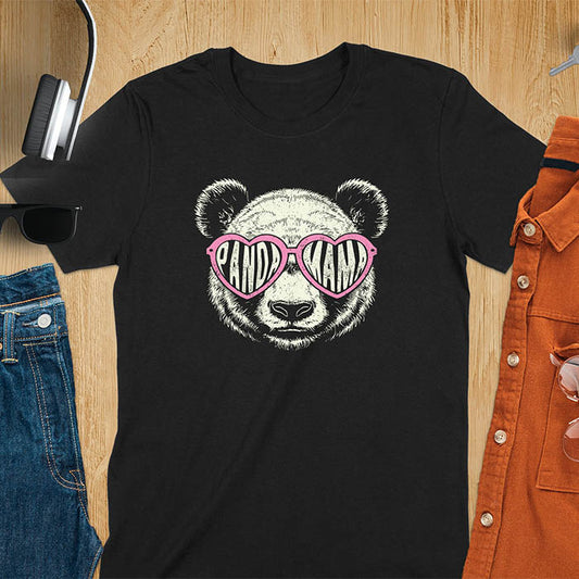 A t-shirt featuring a white panda face with pink heart-shaped sunglasses that spell PANDA MAMA. This mama shirt is a vintage mama t-shirt for a funny animal mom. A mom tee for a gift for mom or gift for grandmother. A mom birthday gift or gift for wife, or an expectant mom gift for a pregnancy announce. A great mother days shirt for mama.
