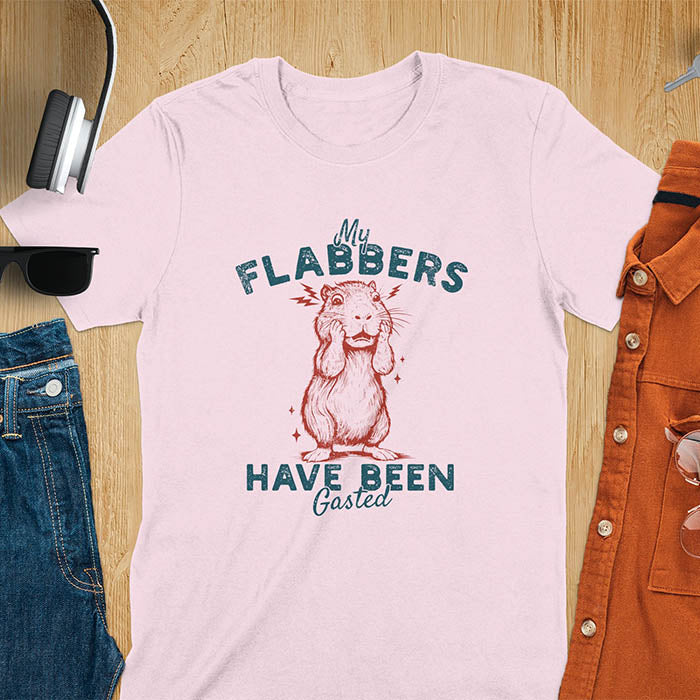 A t-shirt with a startled baby capybara covering its mouth. Text: "My FLABBERS Have Been GASTED". This sarcastic t-shirt is weird silly funny, a Gen Z meme tee & funny gag gift. It has weirdcore memes, vintage retro unhinged tee-shirt appeal & makes shirts that go hard. An animal person gift, animal lover gift, cute animal lover gift, gift mom hers, for kawaiiness cuteness.