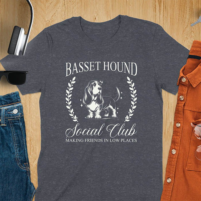 A t-shirt featuring a vintage-style basset hound design. Includes Basset Hound, Social Club, Short & Sweet Forever text, laurel wreaths, EST 2024, and a centered dog illustration for a timeless, elegant look.