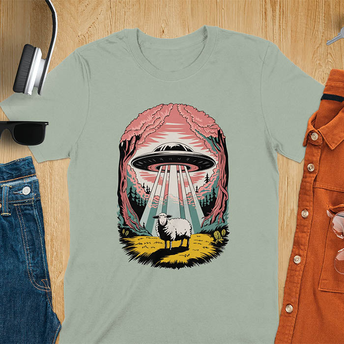 A t-shirt with a UFO hovering over a sheep in a forest scene. This alien tshirt depicts ufo alien abductions with a cute sheep. A weird shirt and funny alien gift, one of those oddly specific tees. A graphic tee-shirt with a 90s graphic tee style. A farm animal gifts or animal person gift. A farmer t shirt or farming shirt, a mom gift alternative.