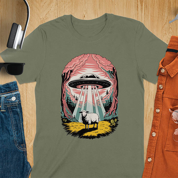 A t-shirt with a UFO hovering over a sheep in a forest scene. This alien tshirt depicts ufo alien abductions with a cute sheep. A weird shirt and funny alien gift, one of those oddly specific tees. A graphic tee-shirt with a 90s graphic tee style. A farm animal gifts or animal person gift. A farmer t shirt or farming shirt, a mom gift alternative.