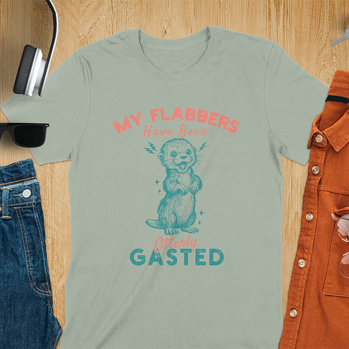 A t-shirt with a startled-looking otter holding its paws in front of its chest. Sparkles surround the otter. Text: "MY FLABBERS" above and "HAVE BEEN Otterly GASTED" below. This weird silly funny tee shows Kawaiiness cuteness and Otter cuteness, a great Otter lover gift. A Sarcastic t-shirt and Funny gag gift, a Gen Z meme tee tapping into Weirdcore memes. An Animal person gift and Gift for mom, hers, one of the Shirts that go hard featuring a Cute sea otter.