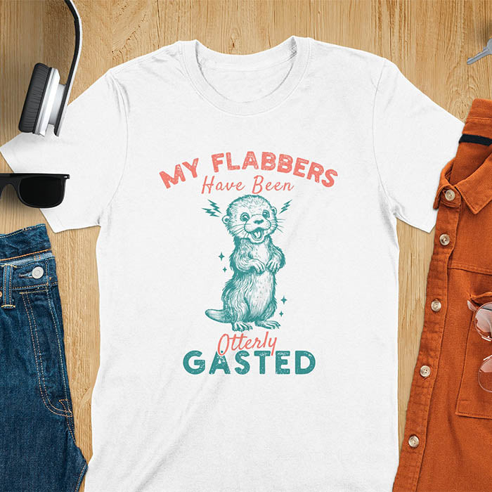 A t-shirt with a startled-looking otter holding its paws in front of its chest. Sparkles surround the otter. Text: "MY FLABBERS" above and "HAVE BEEN Otterly GASTED" below. This weird silly funny tee shows Kawaiiness cuteness and Otter cuteness, a great Otter lover gift. A Sarcastic t-shirt and Funny gag gift, a Gen Z meme tee tapping into Weirdcore memes. An Animal person gift and Gift for mom, hers, one of the Shirts that go hard featuring a Cute sea otter.