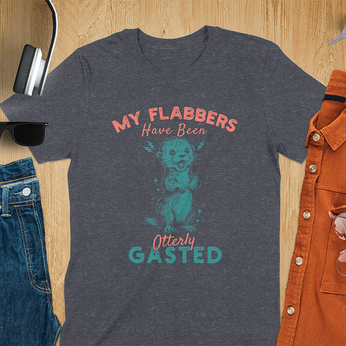 A t-shirt with a startled-looking otter holding its paws in front of its chest. Sparkles surround the otter. Text: "MY FLABBERS" above and "HAVE BEEN Otterly GASTED" below. This weird silly funny tee shows Kawaiiness cuteness and Otter cuteness, a great Otter lover gift. A Sarcastic t-shirt and Funny gag gift, a Gen Z meme tee tapping into Weirdcore memes. An Animal person gift and Gift for mom, hers, one of the Shirts that go hard featuring a Cute sea otter.