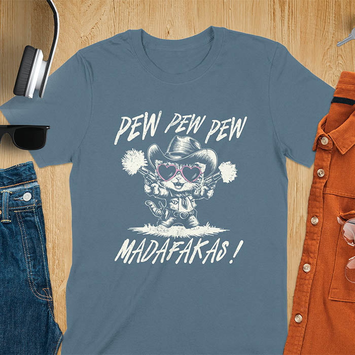A t-shirt with a cat in a cowboy outfit wearing heart sunglasses and holding two pistols. Text: "PEW PEW PEW" above and "MADAFAKAS!" below. This funny meme t shirt features a funny cowboy cat with a sarcastic quote. A funny genz meme and sarcastic meme shirt, a snarky humorous funny adult joke. An animal person gift or gift for mom, a sassy quote funny funny fuck gift.