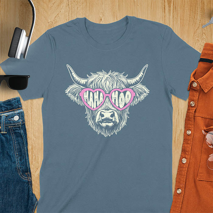 A t-shirt featuring a fluffy highland cow face with long horns, wearing pink heart-shaped sunglasses spelling MAMA MOO. Below the cow, Veronica is written in script font. This retro mom tee-shirt design is a cute cow highlander for mama mom life. A funny animal mom tee for an expecting mom or pregnant mom gift, ideal for a pregnancy announcement or pregnancy reveal. A great mom gift or Mother days gift, or a new mom gift for a gift for wife. The name can be personalized.