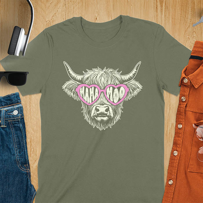 A t-shirt featuring a fluffy highland cow face with long horns, wearing pink heart-shaped sunglasses spelling MAMA MOO. Below the cow, Veronica is written in script font. This retro mom tee-shirt design is a cute cow highlander for mama mom life. A funny animal mom tee for an expecting mom or pregnant mom gift, ideal for a pregnancy announcement or pregnancy reveal. A great mom gift or Mother days gift, or a new mom gift for a gift for wife. The name can be personalized.