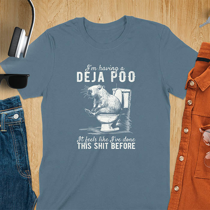 A t-shirt with a capybara seated on a toilet bowl. Text: "I'm having a Deja Poo It feels like I've done THIS SHIT BEFORE". A Capybara Deja Poo Shirt with Toilet Humor Gag Gift appeal. Inappropriate, offensive, weirdcore, funny meme, trending meme, genz gen z tee. Features kawaiiness, capybara cuteness, weird capybara gift. Great for animal person, pet lovers, animal lover, gift mom hers. A Retro Graphic Tshirt, y2k tee-shirt, Vintage Silly Party Tees, shirts that go hard.