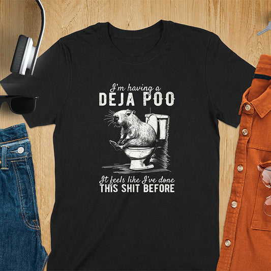 A t-shirt with a capybara seated on a toilet bowl. Text: "I'm having a Deja Poo It feels like I've done THIS SHIT BEFORE". A Capybara Deja Poo Shirt with Toilet Humor Gag Gift appeal. Inappropriate, offensive, weirdcore, funny meme, trending meme, genz gen z tee. Features kawaiiness, capybara cuteness, weird capybara gift. Great for animal person, pet lovers, animal lover, gift mom hers. A Retro Graphic Tshirt, y2k tee-shirt, Vintage Silly Party Tees, shirts that go hard.