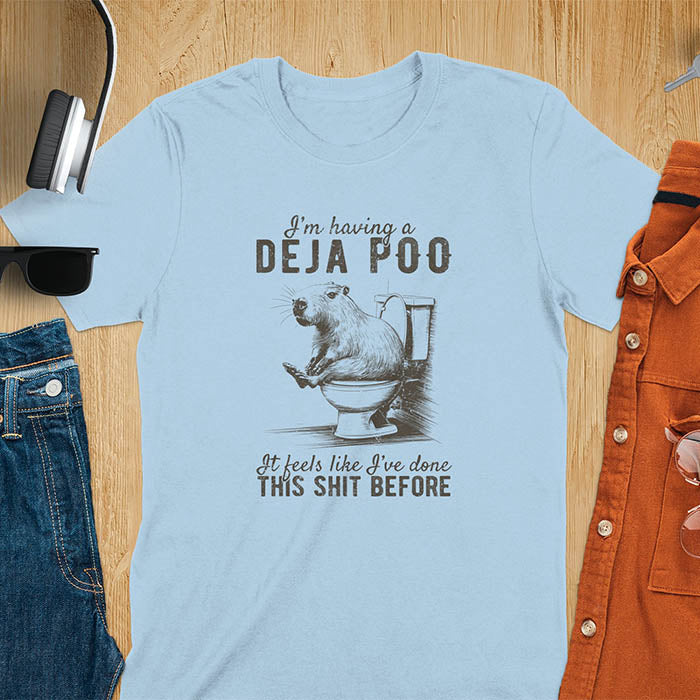 A t-shirt with a capybara seated on a toilet bowl. Text: "I'm having a Deja Poo It feels like I've done THIS SHIT BEFORE". A Capybara Deja Poo Shirt with Toilet Humor Gag Gift appeal. Inappropriate, offensive, weirdcore, funny meme, trending meme, genz gen z tee. Features kawaiiness, capybara cuteness, weird capybara gift. Great for animal person, pet lovers, animal lover, gift mom hers. A Retro Graphic Tshirt, y2k tee-shirt, Vintage Silly Party Tees, shirts that go hard.