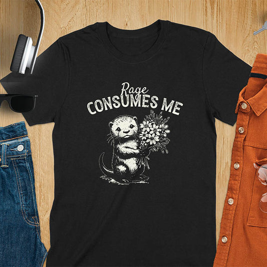 A t-shirt with an otter holding flowers. Text: "Rage CONSUMES ME" above. This dark humor tee features otter cuteness and cuteness kawaii, a mental health meme. A genz meme gift and weird funny t shirt, a funny gag gift or animal lover gag. One of those shirts that go hard, an unhinged tshirt. A mom gift hers or animal person gift with a retro graphic tee style.