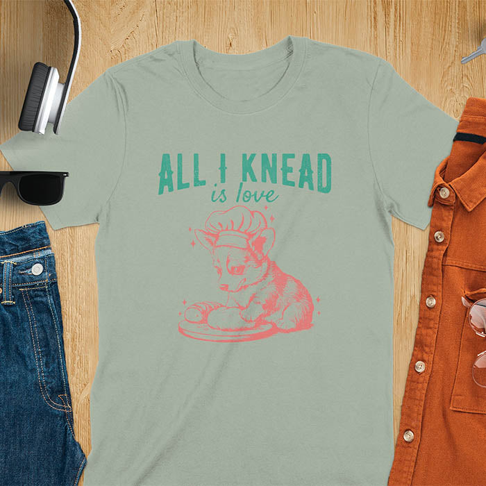 Sage green t-shirt with a cute corgi baking t-shirt - featuring cartoon dog in chef hat with All I Knead Is Love text

