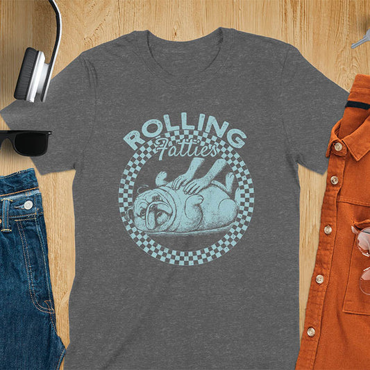 Dark heather colored unisex t-shirt featuring 'Rolling Fatties' text in blue lettering above a cute chubby bulldog lying on its back within a blue and white checkered circle border