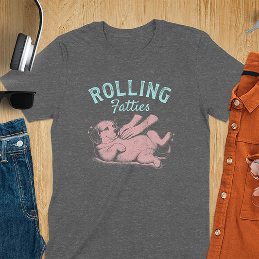 Dark heather t-shirt featuring 'Rolling Fatties' text in teal lettering above a chubby beagle dog lying on its back in red/burgundy ink sketch style