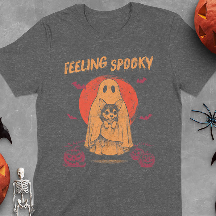 Dark heather t-shirt featuring a ghost holding a corgi puppy with 'Feeling Spooky' text above, red moon background with bats and jack-o'-lanterns