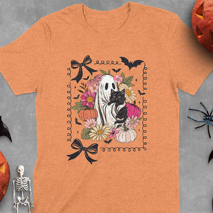 Heather Orange t-shirt featuring cute ghost holding black cat surrounded by pumpkins, bats, and floral elements in cottagecore coquette style