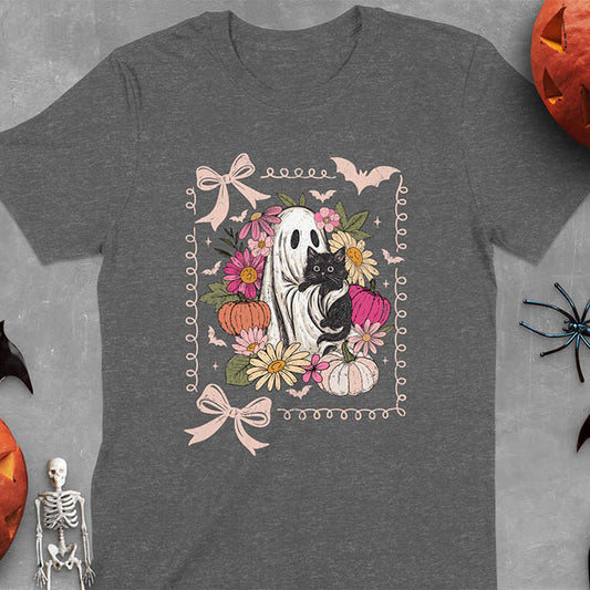 Dark heather t-shirt featuring cute ghost holding black cat surrounded by pumpkins, bats, and floral elements in cottagecore coquette style