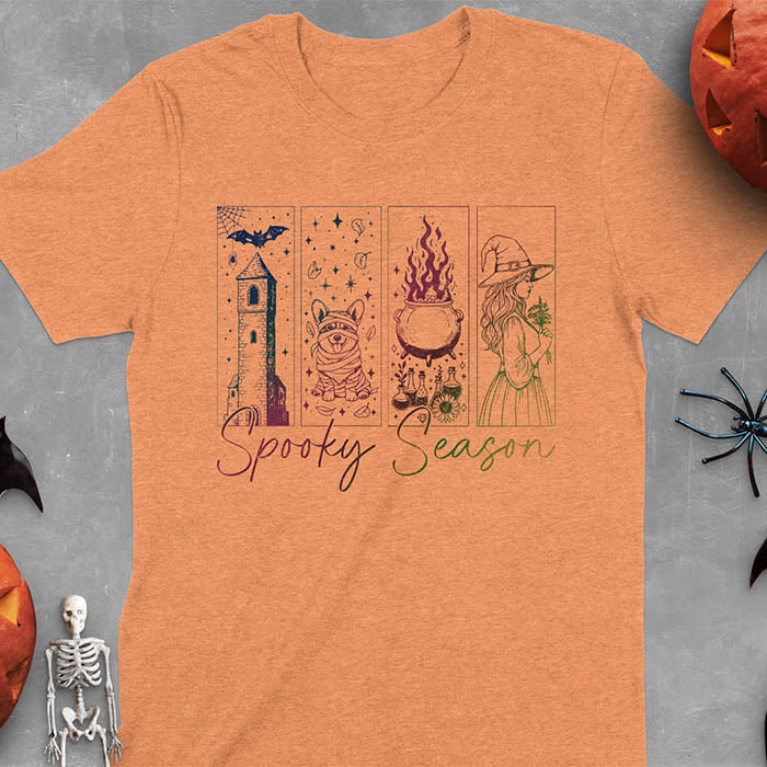 Heather Orange t-shirt featuring four ombre color panels with haunted house, mummy corgi, bubbling cauldron, and witch figure, with 'Spooky Season' text below