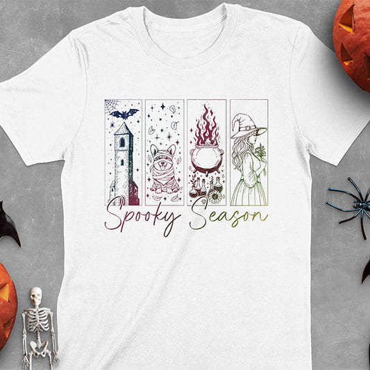 White t-shirt featuring four ombre color panels with haunted house, mummy corgi, bubbling cauldron, and witch figure, with 'Spooky Season' text below