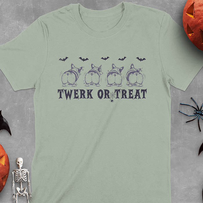 Sage green t-shirt with Funny Halloween Corgi Twerk or Treat T-Shirt - Four Corgis showing their butts in Halloween theme