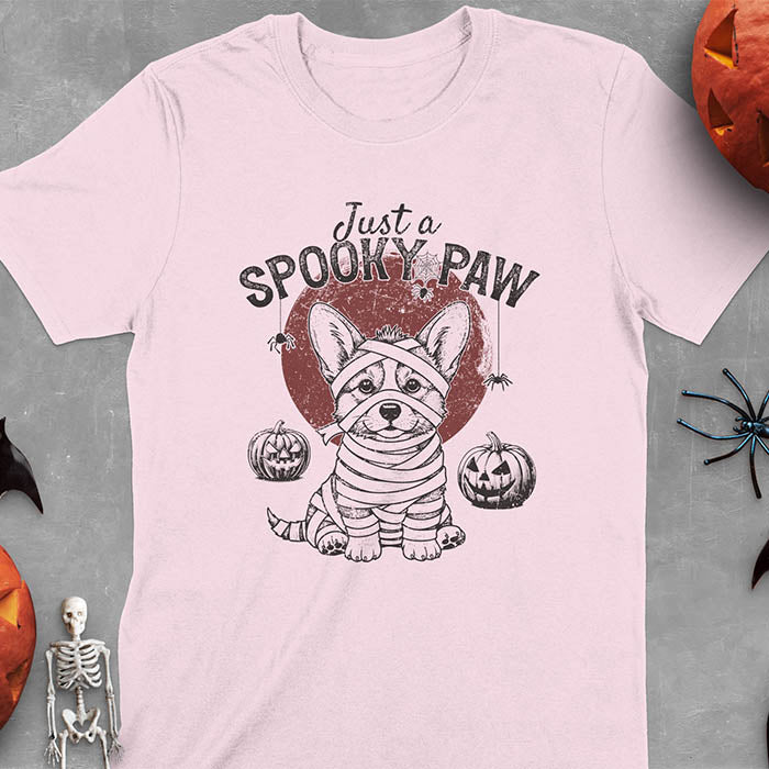 Light Pink t-shirt with Halloween mummy corgi featuring "Just a Spooky Paw" text and wrapped corgi graphics