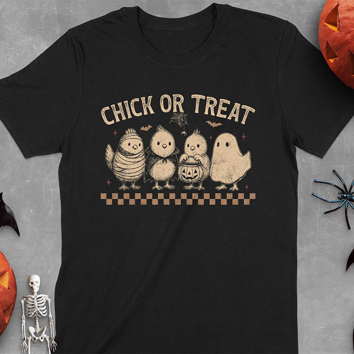 Black t-shirt with Funny Halloween Chick Or Treat text featuring cartoon chickens dressed as spooky characters including ghost, mummy, vampire, and trick-or-treater