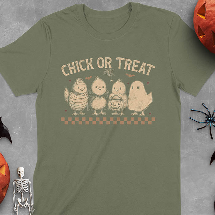 Military Green t-shirt with Funny Halloween Chick Or Treat text featuring cartoon chickens dressed as spooky characters including ghost, mummy, vampire, and trick-or-treater
